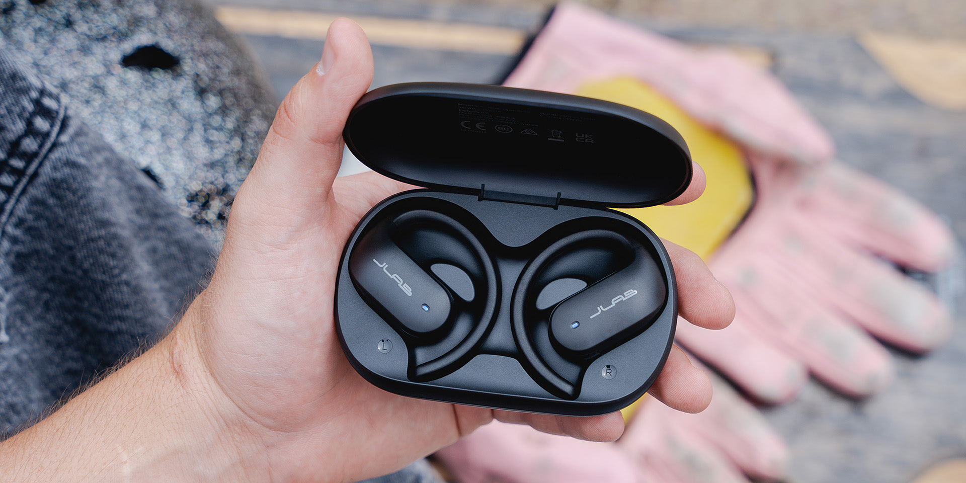 JBuds Open Sport Earbuds in hand