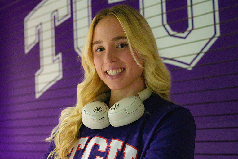 Haley wearing Jbuds Lux Headphones