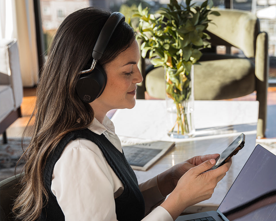 Woman wearing Epic Lux Lab Edition headphones while using her phone