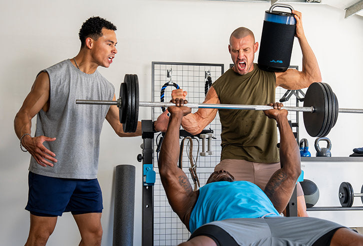 Men working out with the jlab speaker
